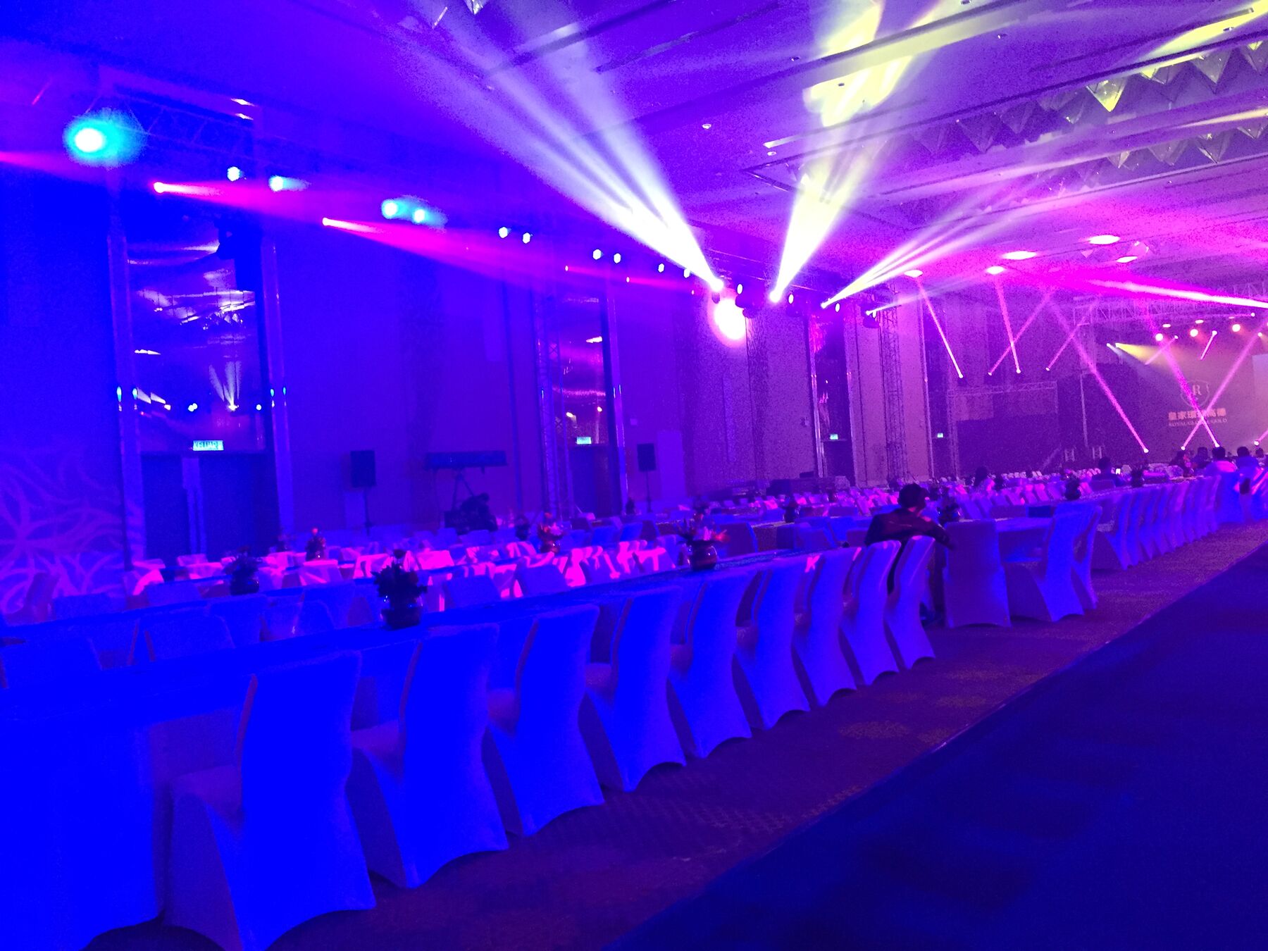 Gala dinner stage with orange spotlight beams