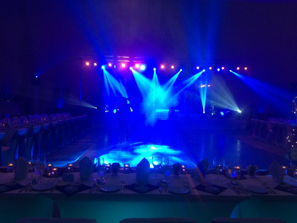 Blue moving-head beams over wedding dance floor
